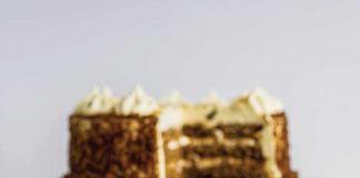 Carrot Cake with a slice on a plate in front of it