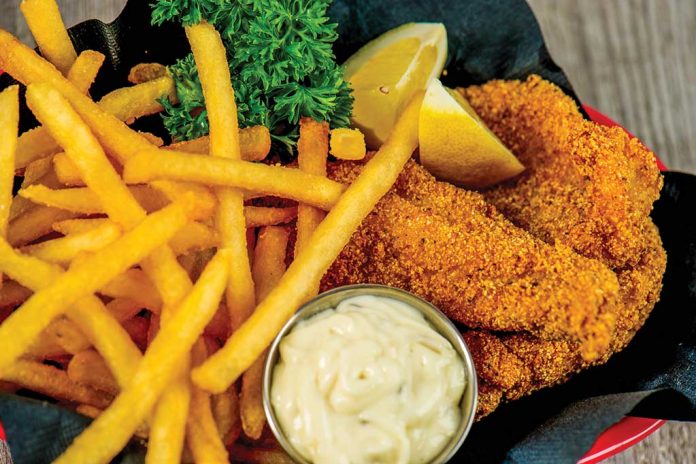 Fried Catfish Fried Catfish in a basket with fries and lemon wedges