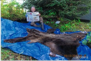 vac_bergmeyer Bob Bergmeyer, of Canton, Ohio, takes a break to read Farm and Dairy while bear hunting in Cordova, Alaska. Bergmeyer spent his birthday in Alaska, hunting brown bear and moose. He got a bear his second day out, but while he was out hunting moose later, the bears ransacked his campsite. He still had a good time visiting with friends -- and he came home with a bear and about 50 pounds of halibut!