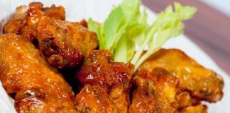 Honey Glazed Chicken Wings in bowl with celery.