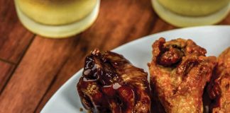 Teriyaki Chicken Wings on a plate with Ranch Dressing in a bowl in the middle of the wings.