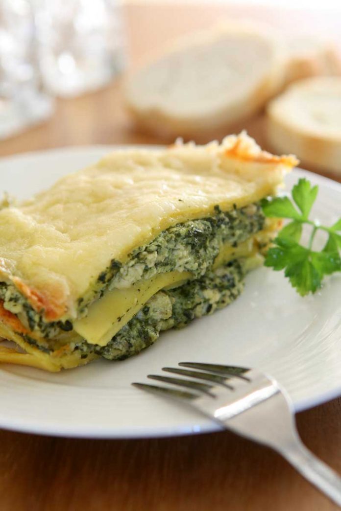 Four Cheese Spinach Lasagna A piece of Four Cheese Spinach Lasagna on a white dinner plate.