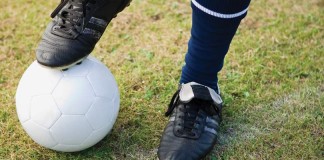 boy's foot on soccer ball