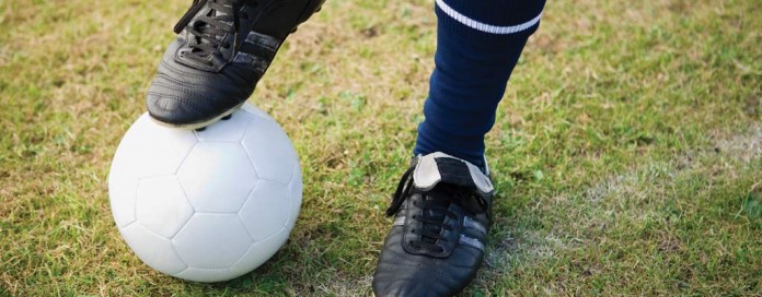 boy's foot on soccer ball boy's foot on soccer ball