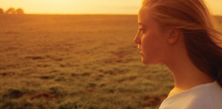 girl and sunset over farmland