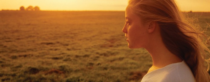 girl and sunset over farmland girl and sunset over farmland