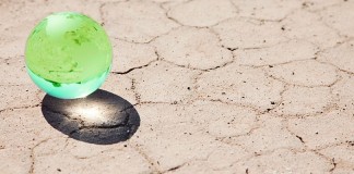marble globe on parched ground