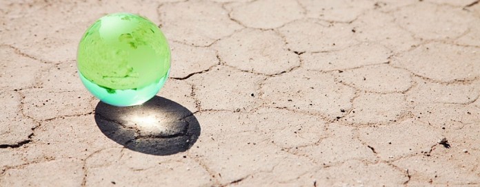 globe marble on parched ground marble globe on parched ground