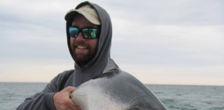 fisherman holding salmon