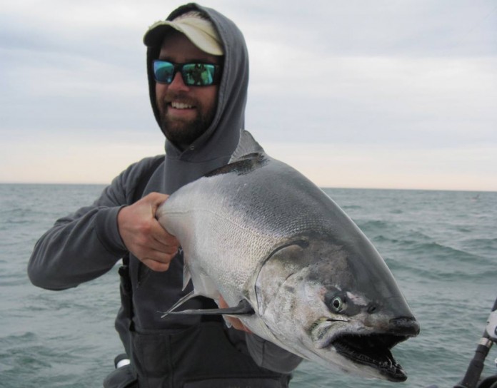 fisherman holding salmon fisherman holding salmon