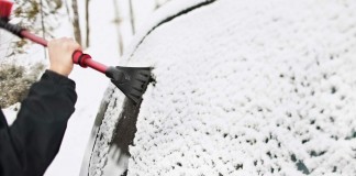 scraping snow and ice off of car windows