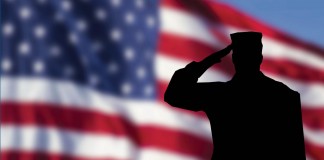 American flag and saluting soldier