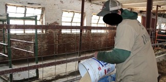 Inmate pouring feed