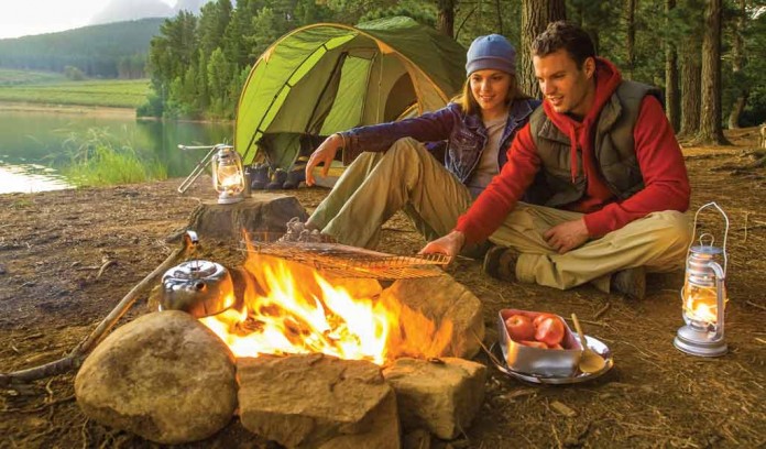 couple sitting by campfire couple sitting by campfire