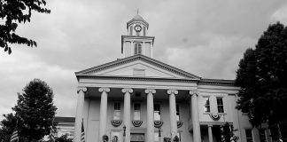 The tall clock tower and looming white pillars of the Lawrence County, Pennsylvania Courthouse stands tall against the cloudy sky as another day in Drug Court begins.