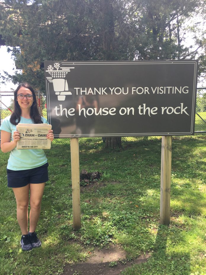 Lisa Kalas: Vacation With Us in Madison Wisconsin Lisa Kalas holding the Farm and Dairy Newspaper standing next to a sign that reads