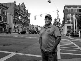 Brent Bennet stands on the corner of a Huron County street