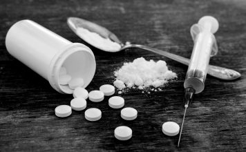 Opioids and their impact on our rural counties Pills, Fentynal Powder, and Heroin syringe sit on a table