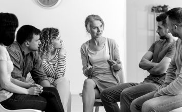 Where to get help A diverse group of people sit and talk during a group counseling session.