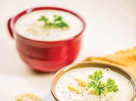 Two bowls of potato soup sit waiting to be eaten.