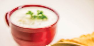 Two bowls of potato soup sit waiting to be eaten.