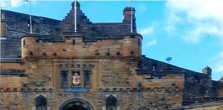The Larricks standing in front of Edinbugh Castle in Scotland with their Farm and Dairy