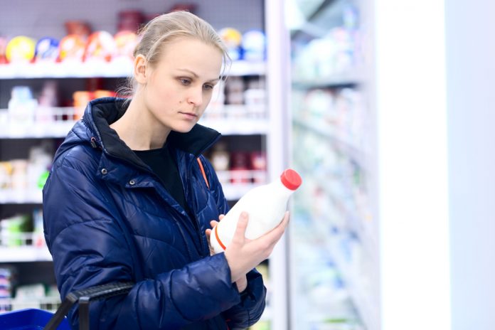 att-grocery-storm Woman buying milk at the store before a snowstorm