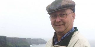 Mark Holian reads the Farm and Dairy at the Cliffs of Moher in Ireland