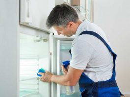 Man cleaning fridge