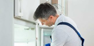 Man cleaning fridge