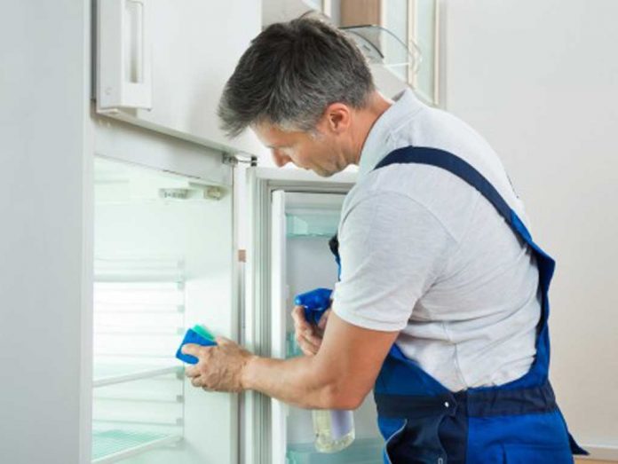 man-cleaning-fridge Man cleaning fridge