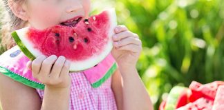 little girl eating watermelon