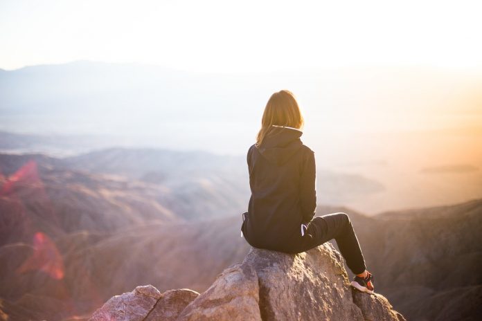 girl sitting on mountain girl sitting on mountain