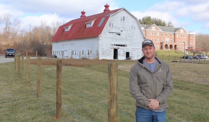 New_Lex_FFA_farm John Lindsey, an FFA adviser at New Lexington, standing in front of school farm.
