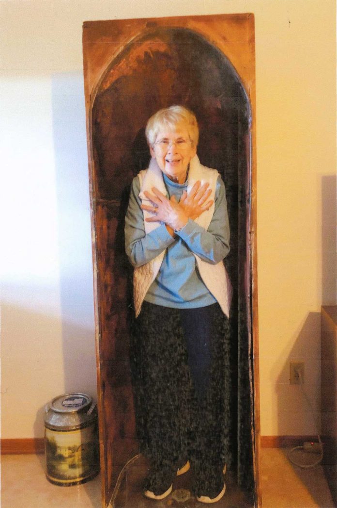 Hazard a Guess No. 1126 A woman stands inside of a large opening in this antique item.