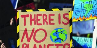 Protestors holding climate change banners at a protest