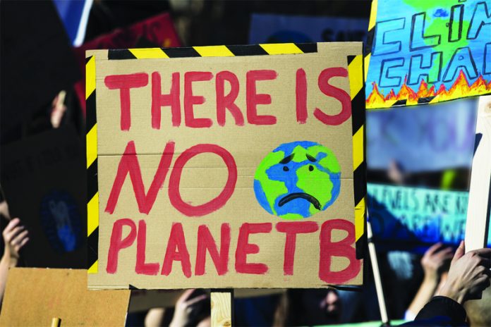 Protestors holding climate change banners at a protest Protestors holding climate change banners at a protest