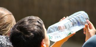 boy drinking from water bottle