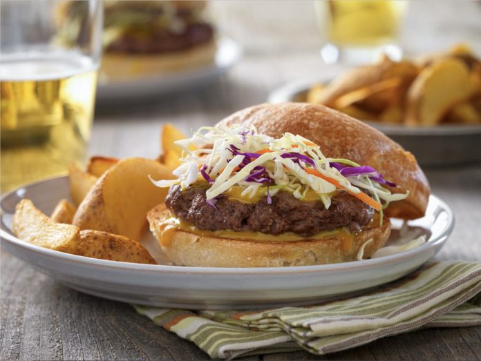 feature.web Carolina Barbecue Burger on a plate with chips.