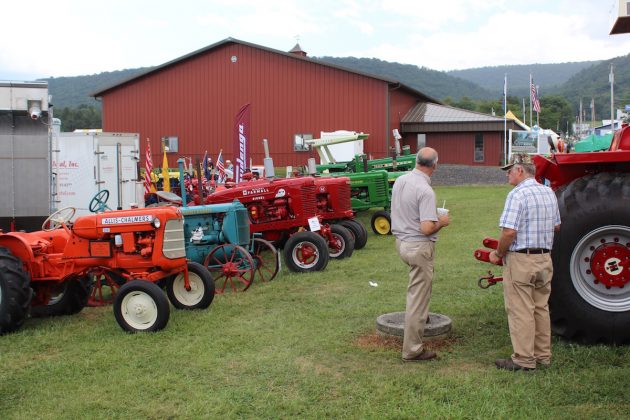 men-look-at-tractors