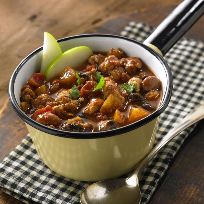 Feature.web A bowl of Apple Turkey Chili garnished with two apple slices.