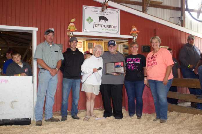 hog_judge1 Darell Furlong stands with Ginny Barker and members of the hog committee after they recognized him with a plaque for his retirement.