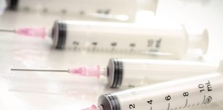 syringes and needles laying on table