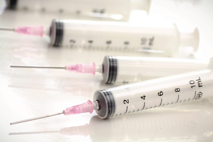 syringes syringes and needles laying on table