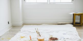painter's trays and rollers on a drop cloth