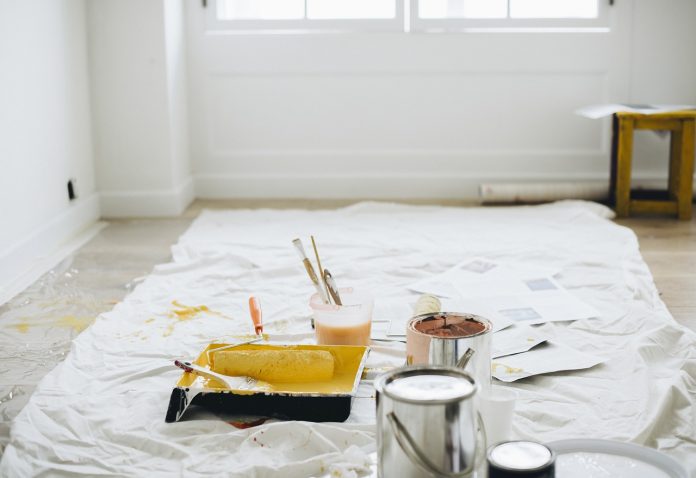 painter's trays and rollers on a drop cloth painter's trays and rollers on a drop cloth