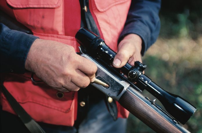 hunter gun hunter loading rifle orange vest