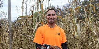 man with pheasant in arms