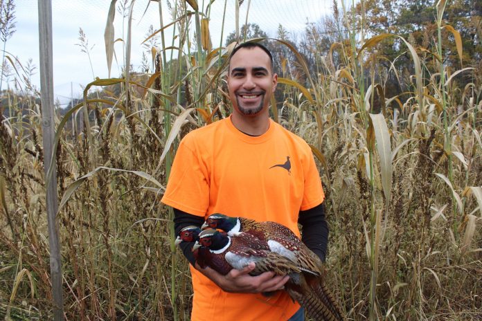 man with pheasant in arms