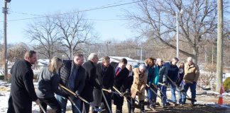 friends and supporters of the fair line up with shovels for the groundbreaking.